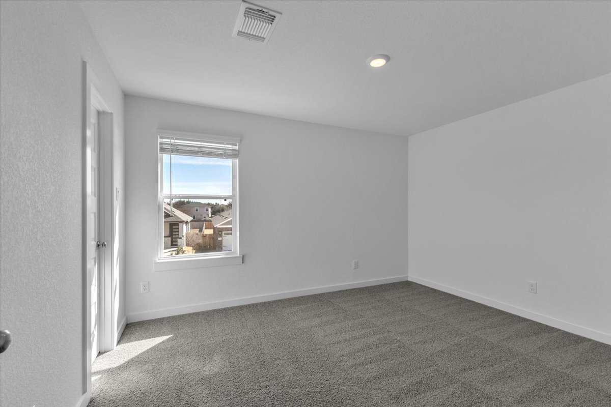 12620 Penguin Path Manor Manor, TX 78653 - Photo 27 of 37 Empty room with carpet and baseboards