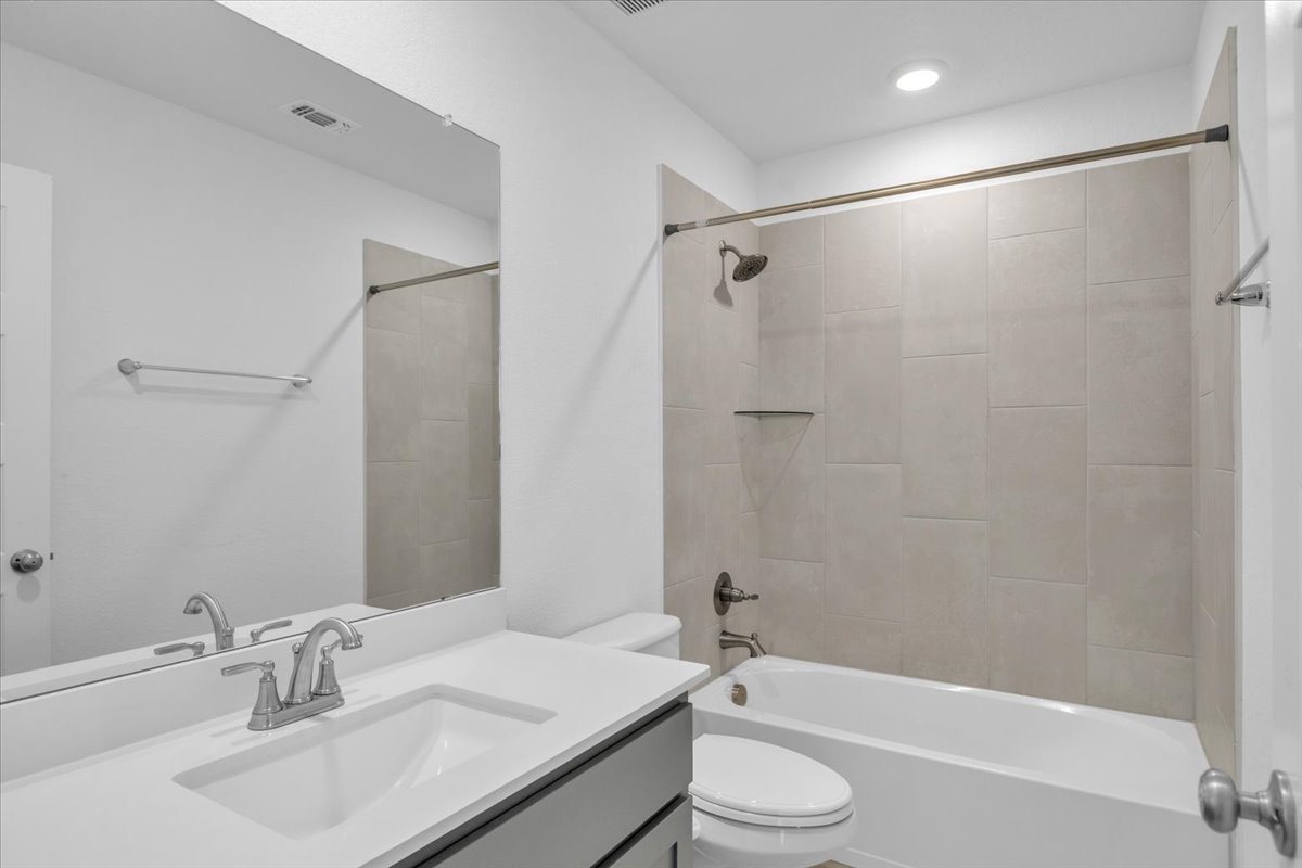12620 Penguin Path Manor Manor, TX 78653 - Photo 28 of 37 Full bathroom with vanity and washtub / shower combination