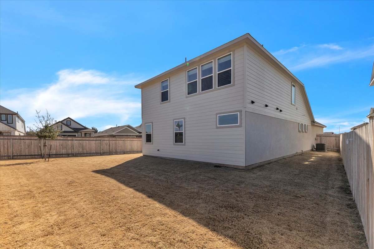12620 Penguin Path Manor Manor, TX 78653 - Photo 32 of 37 Back of property with a fenced backyard