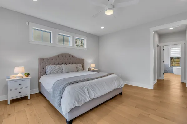 a bedroom with bed and a large window