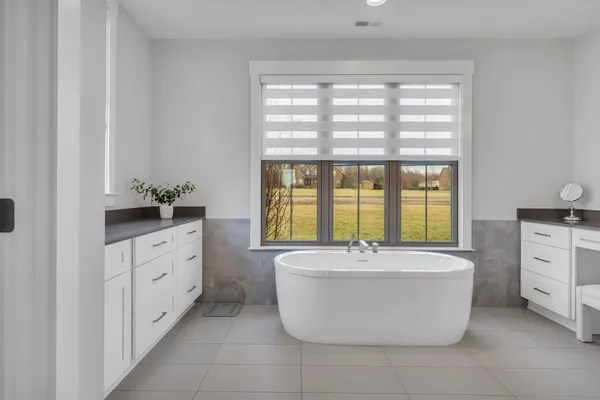 a bathroom with a granite countertop toilet a sink and a mirror