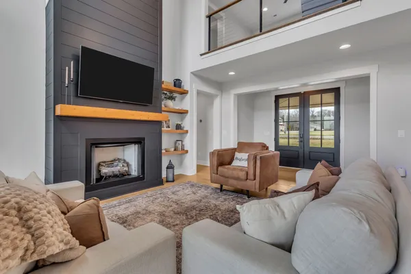 a kitchen with stainless steel appliances kitchen island granite countertop a table chairs in it and wooden floors