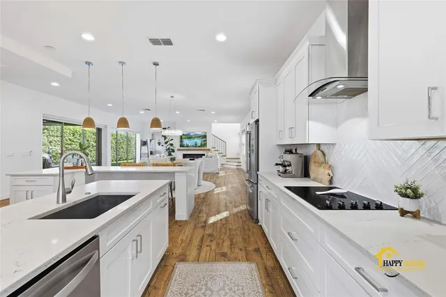 a large kitchen with a table and chairs in it