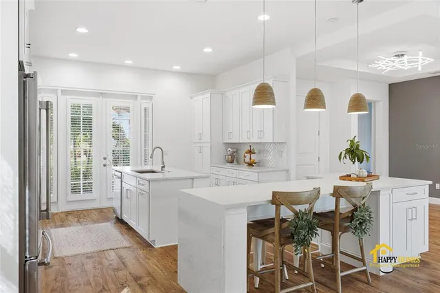 a kitchen with white cabinets and white appliances