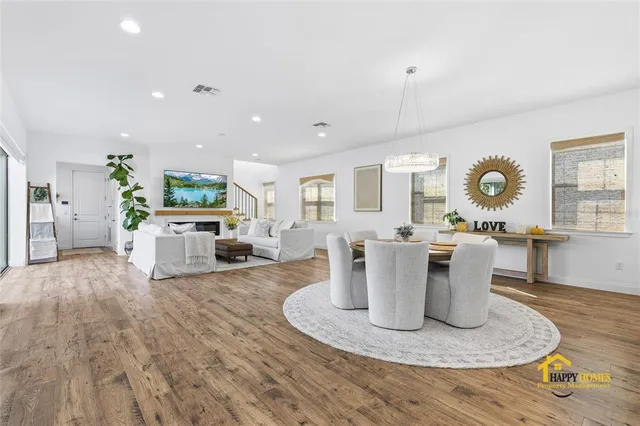 a view of a workspace with wooden floor and furniture