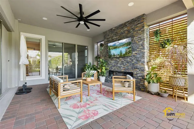 a outdoor living space with furniture and a flat screen tv