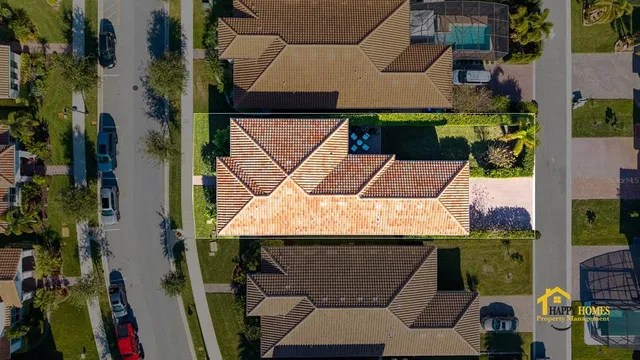 an aerial view of a city with lots of residential buildings and ocean view in back