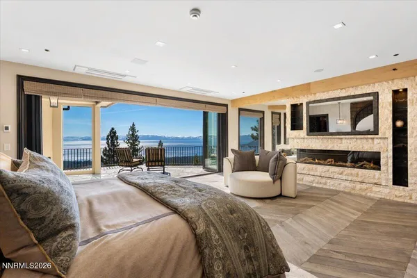 a view of a roof deck with wooden fence and a couple of chairs