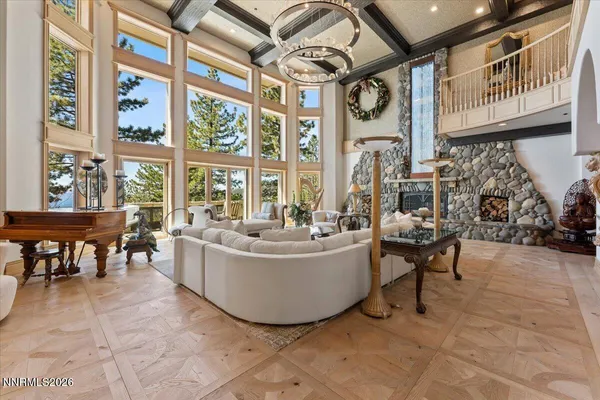 a dining room with furniture a chandelier and window