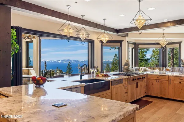 a kitchen with stainless steel appliances kitchen island granite countertop a stove and a refrigerator