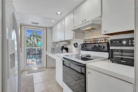a kitchen with stainless steel appliances a stove a sink and a refrigerator