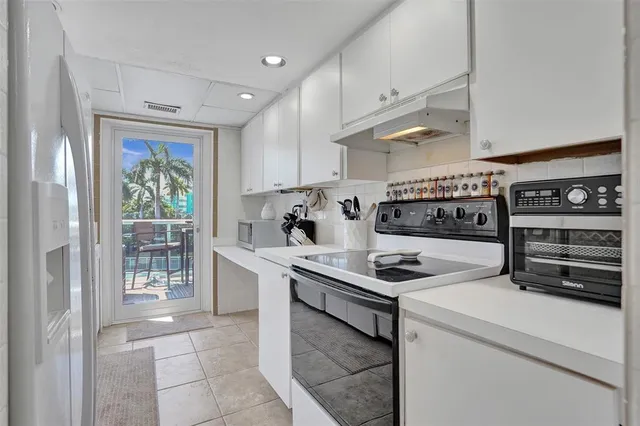 a kitchen with stainless steel appliances a stove a sink and a refrigerator