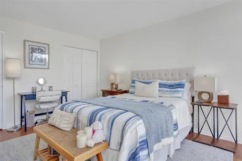 a bedroom with a bed and lamp