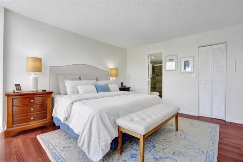 a bedroom with a bed and a dresser