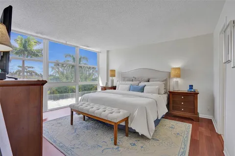 a bedroom with a bed and large window