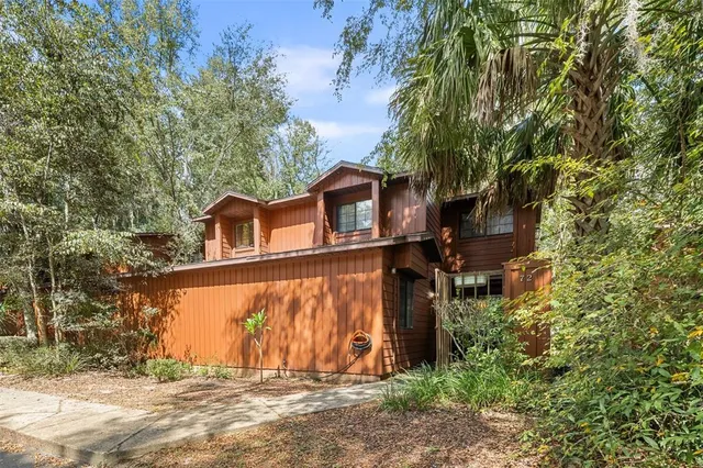 front view of a house with a large tree