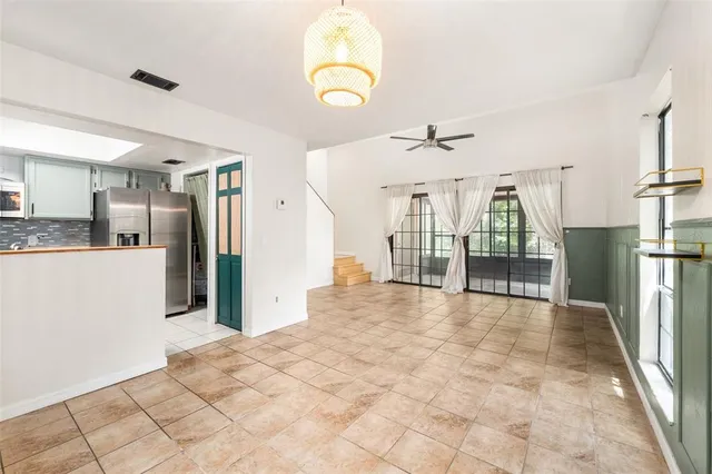 a view of a livingroom with a furniture and floor to ceiling window