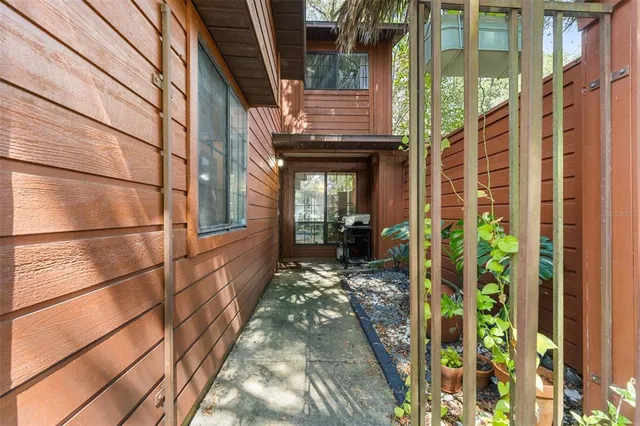 a view of a brick house with a large windows and flower pot