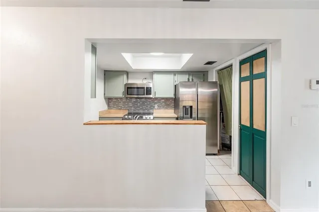 a large kitchen with stainless steel appliances a refrigerator and a stove