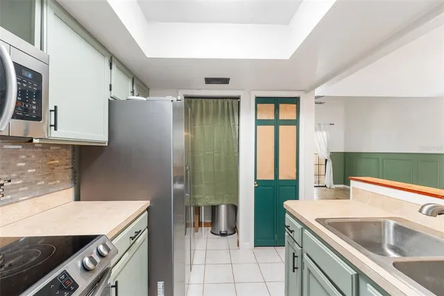 a kitchen with stainless steel appliances granite countertop a refrigerator and a sink