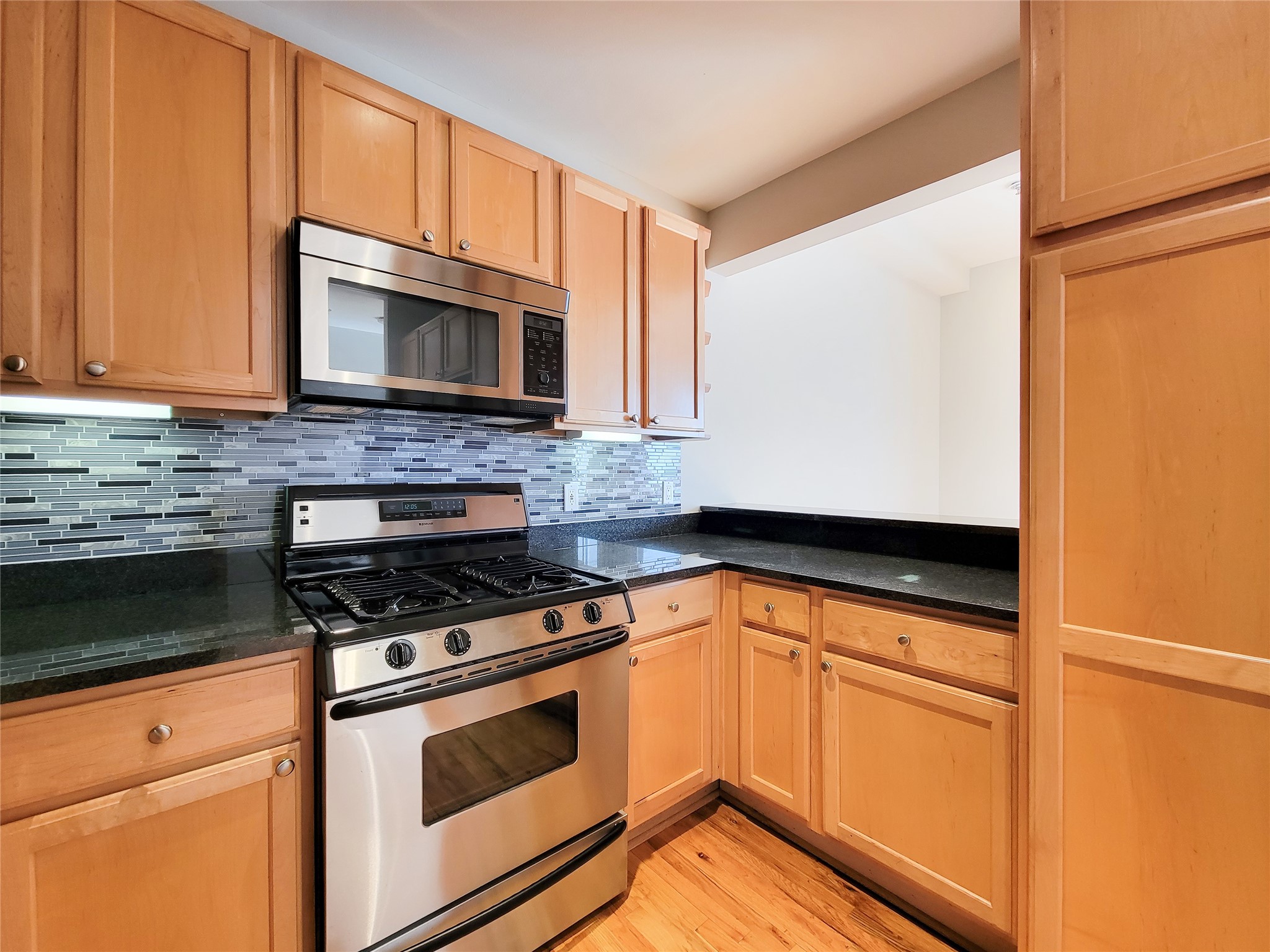 2520 Robinhood Street, Unit 800 Houston, TX 77005 - Photo 12 of 46 a kitchen with granite countertop cabinets stainless steel appliances and a counter space