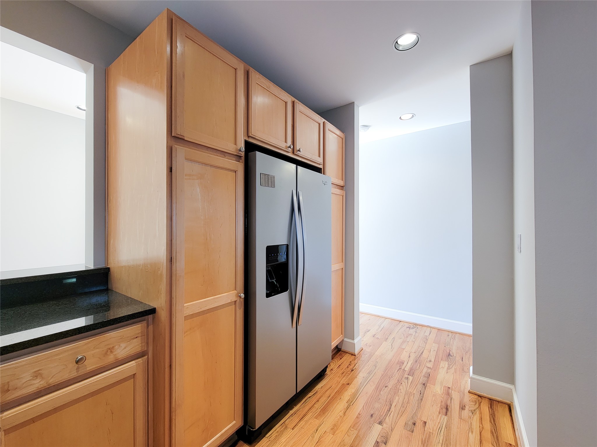 2520 Robinhood Street, Unit 800 Houston, TX 77005 - Photo 13 of 46 a kitchen with stainless steel appliances a refrigerator and wooden floor