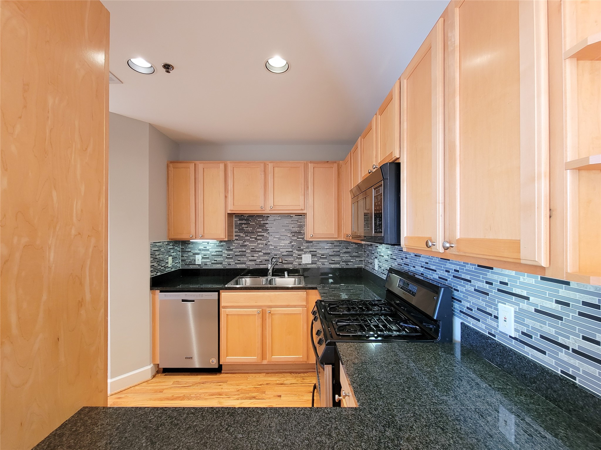 2520 Robinhood Street, Unit 800 Houston, TX 77005 - Photo 14 of 46 a kitchen with granite countertop a sink and a stove