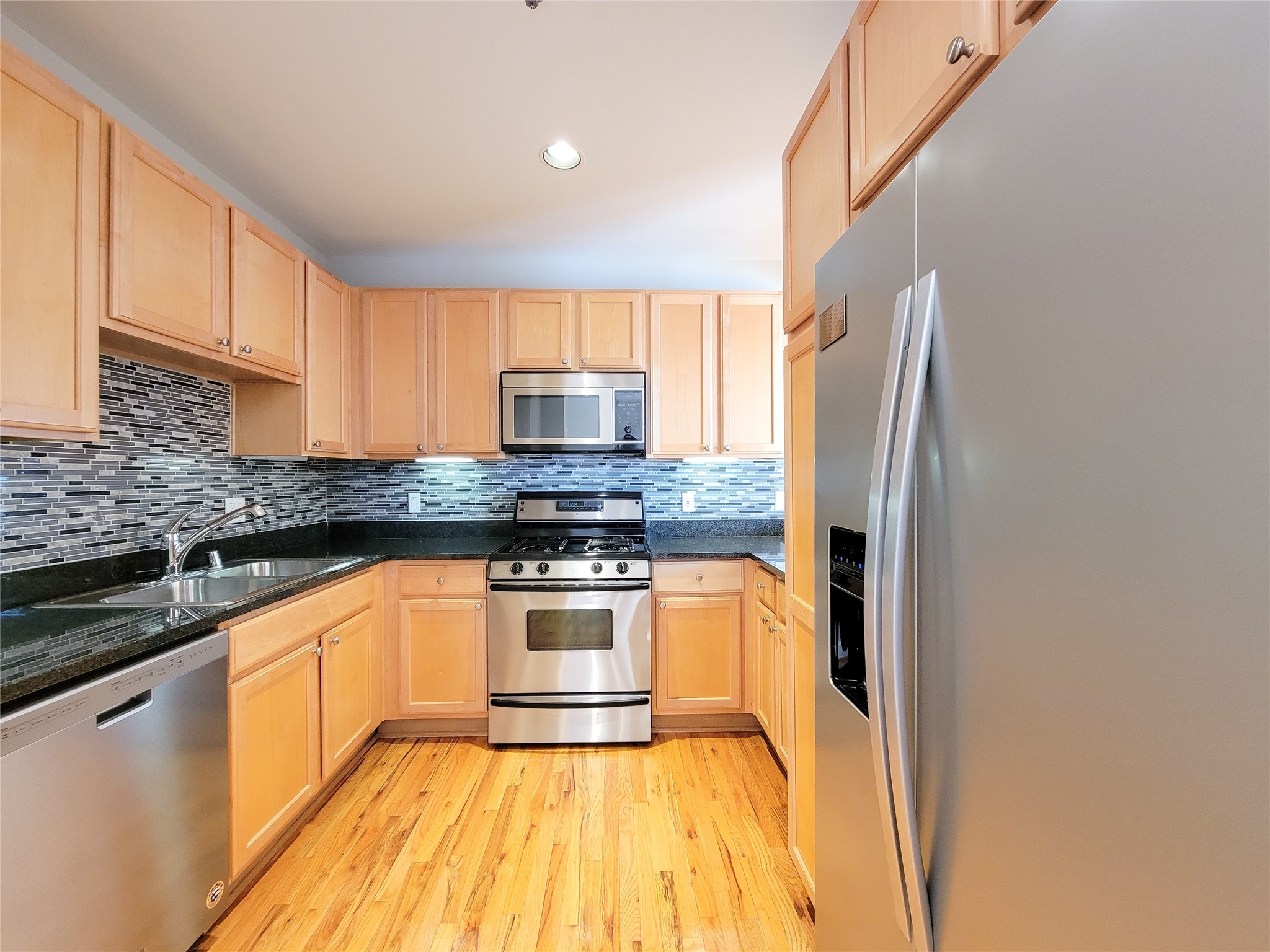 2520 Robinhood Street, Unit 800 Houston, TX 77005 - Photo 10 of 46 a kitchen with stainless steel appliances granite countertop a refrigerator sink and stove