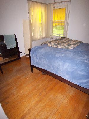 150 North Wolf Road Des Plaines, IL 60016 - Photo 9 of 16 a bedroom with a bed and wooden floor