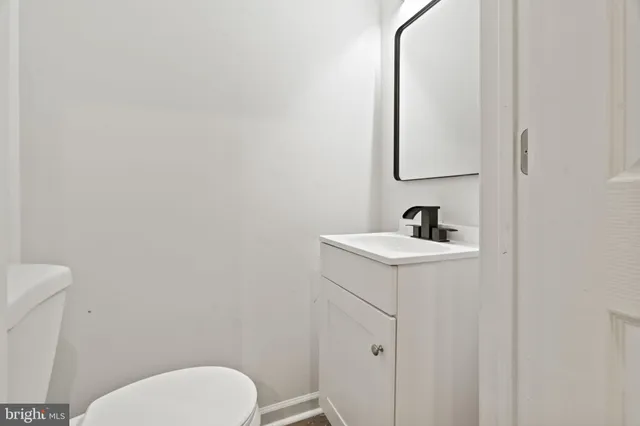 a white toilet sitting next to a bathroom sink