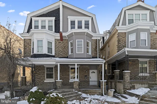 a front view of a house with many windows