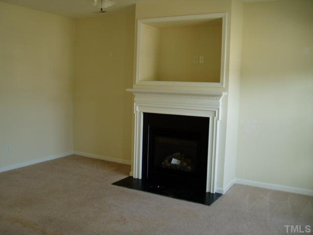 5904 Wynmore Road Raleigh, NC 27610 - Photo 3 of 10 a room with a fireplace