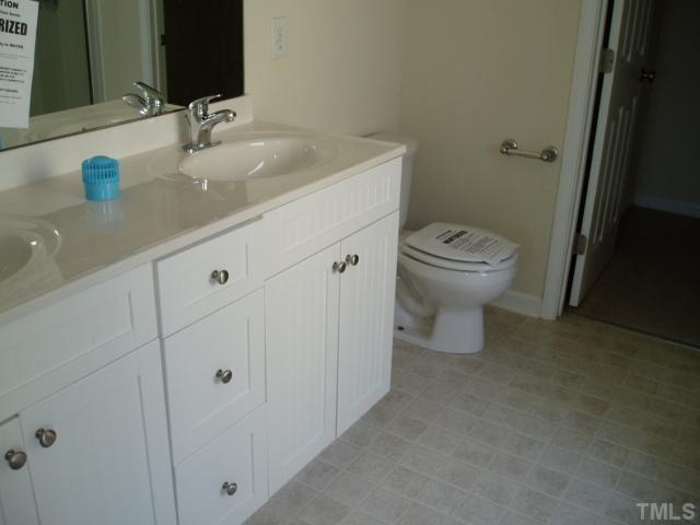 5904 Wynmore Road Raleigh, NC 27610 - Photo 9 of 10 a bathroom with a sink toilet and vanity