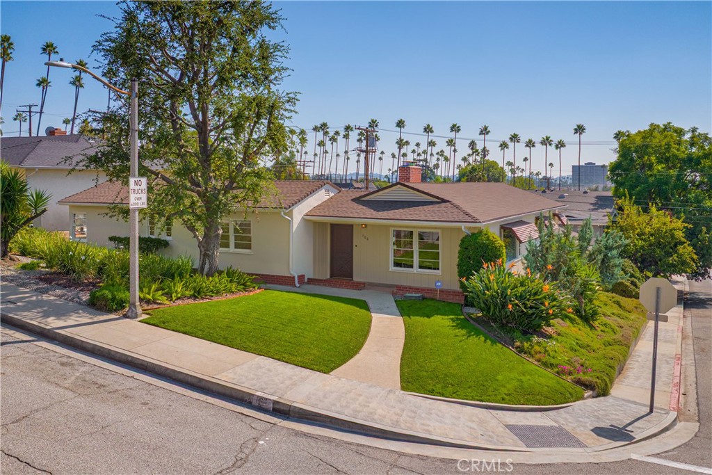100 East Kenneth Road Glendale, CA 91207 - Photo 1 of 1 a view of a white house with a yard potted plants and a fountain