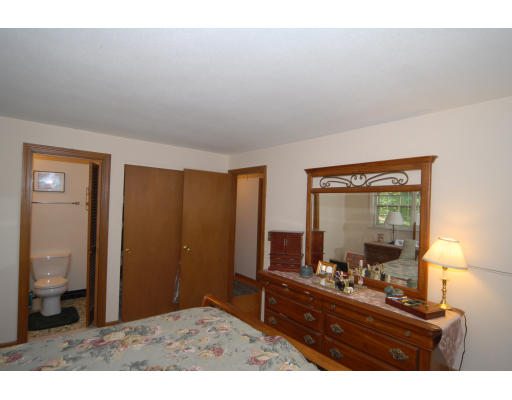 12 Tamarack Road Natick, MA 01760 - Photo 12 of 26 a living room with a mirror on dresser and a table