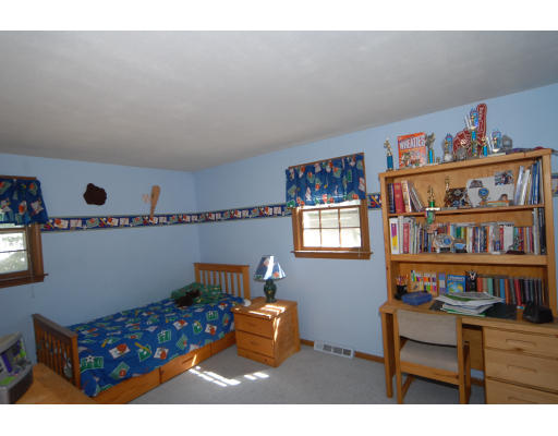 12 Tamarack Road Natick, MA 01760 - Photo 13 of 26 a living room with furniture and a book shelf
