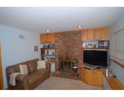 12 Tamarack Road Natick, MA 01760 - Photo 16 of 26 a living room with furniture a flat screen tv and a fireplace