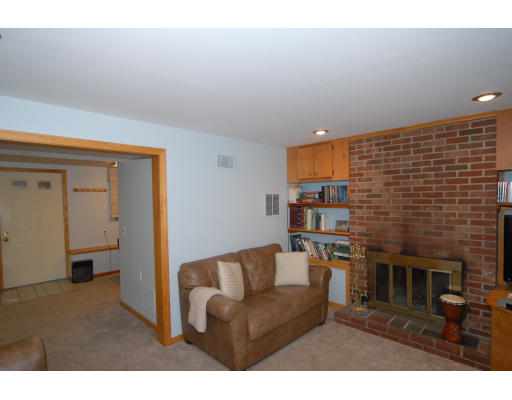 12 Tamarack Road Natick, MA 01760 - Photo 17 of 26 a living room with furniture a flat screen tv and a fireplace