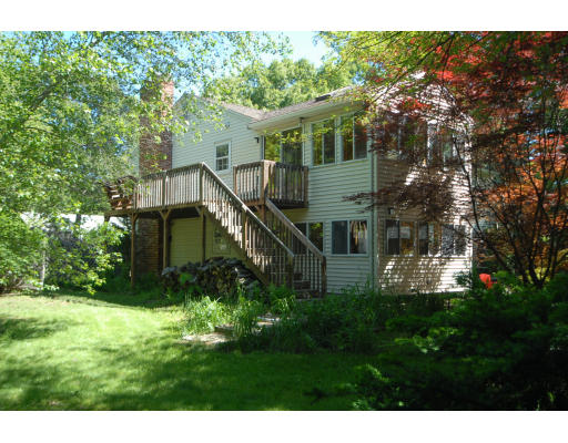 12 Tamarack Road Natick, MA 01760 - Photo 23 of 26 a backyard of a house with lots of green space