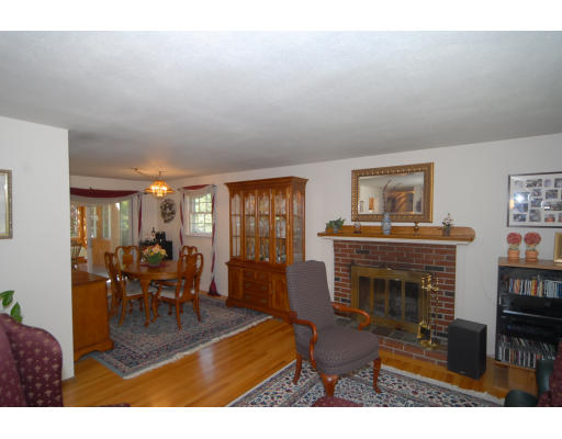 12 Tamarack Road Natick, MA 01760 - Photo 4 of 26 a living room with furniture a fireplace and a flat screen tv