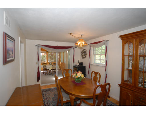 12 Tamarack Road Natick, MA 01760 - Photo 5 of 26 a view of a dining room with furniture and a chandelier