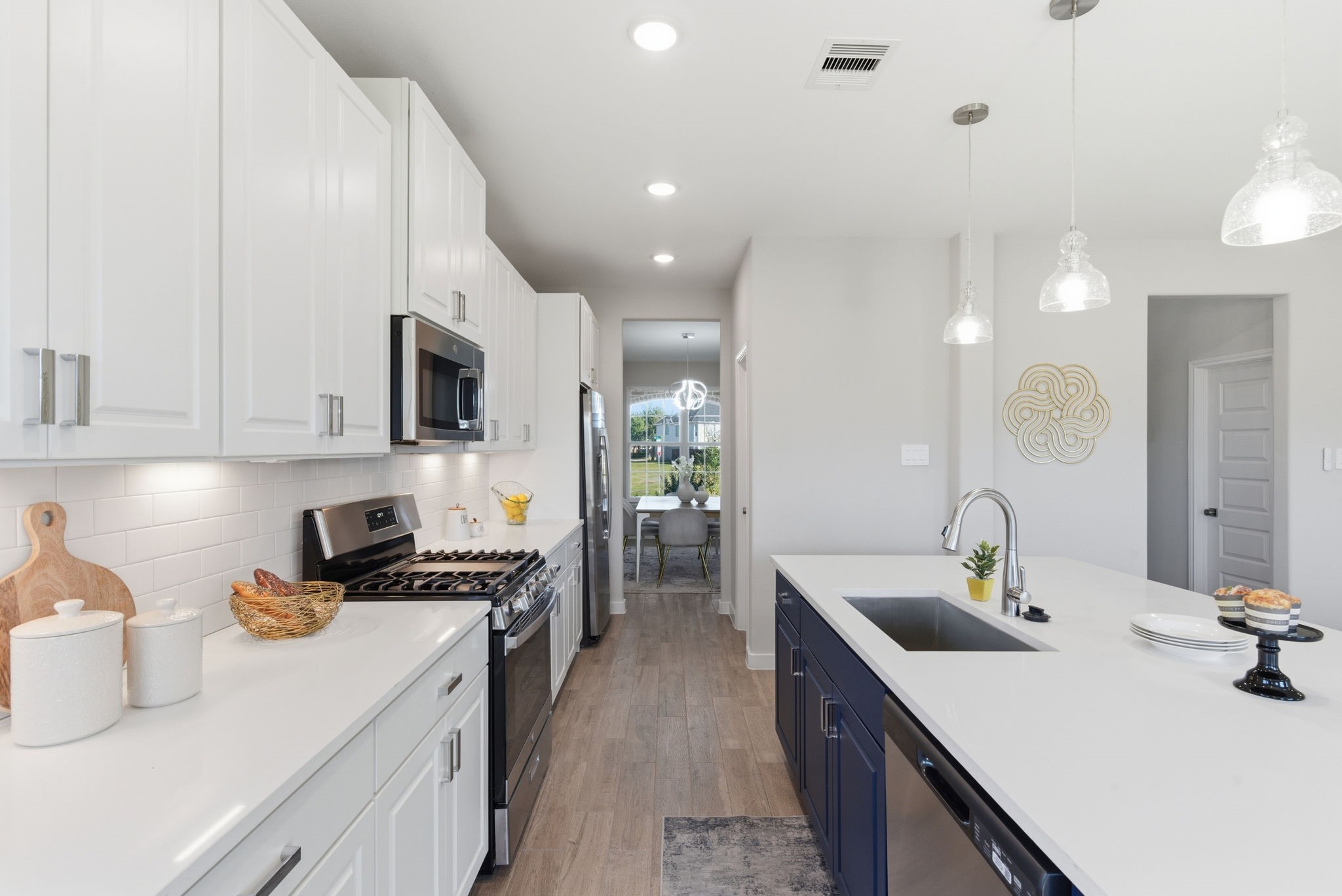 2443 Inlet Court Fresno, TX 77545 - Photo 16 of 50 a kitchen with sink a microwave and cabinets