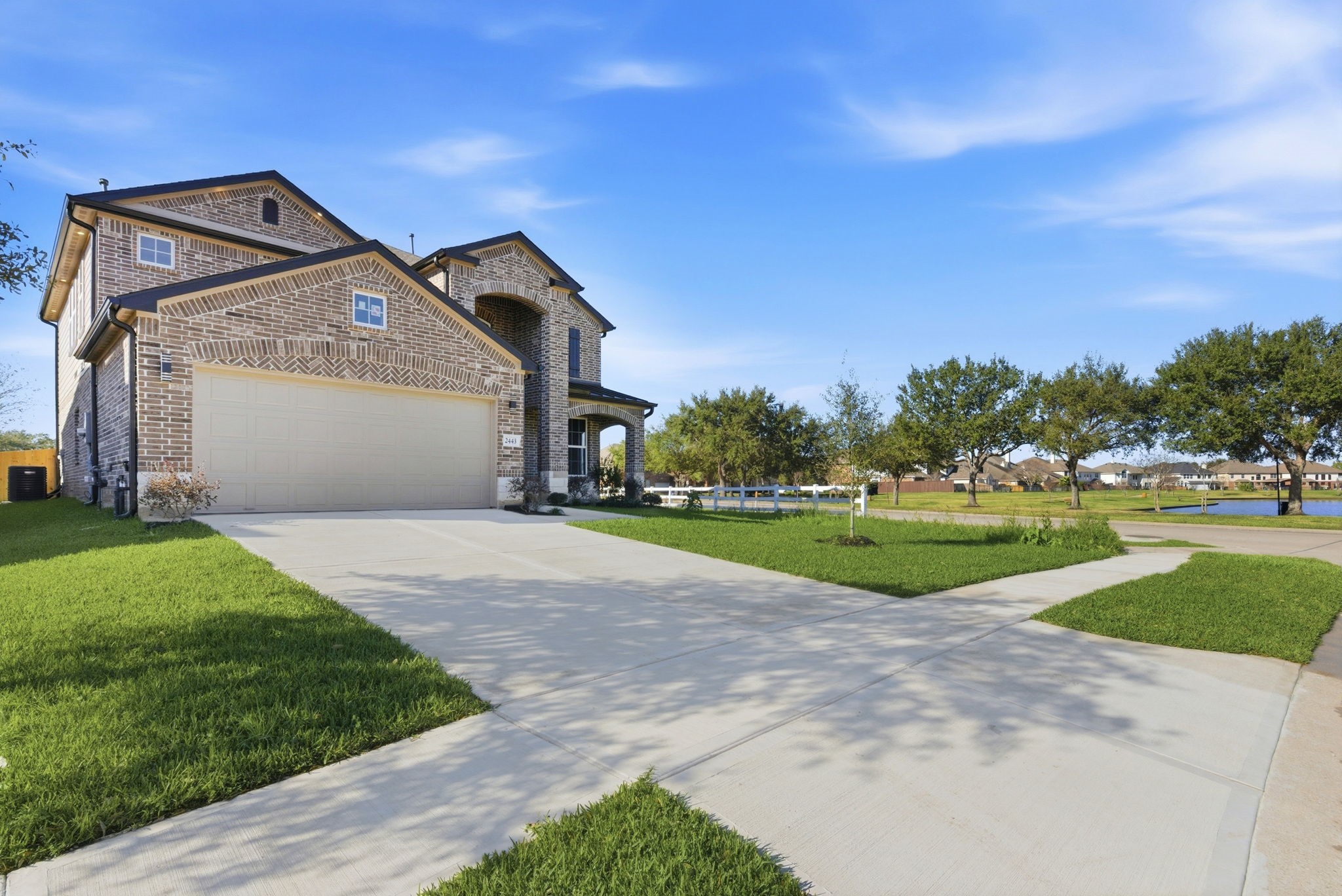 2443 Inlet Court Fresno, TX 77545 - Photo 2 of 50 a view of a big house with a big yard and large trees