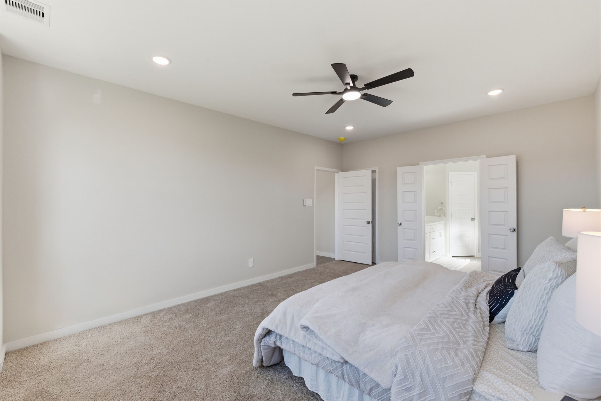 2443 Inlet Court Fresno, TX 77545 - Photo 23 of 50 a bedroom with a bed and a ceiling fan