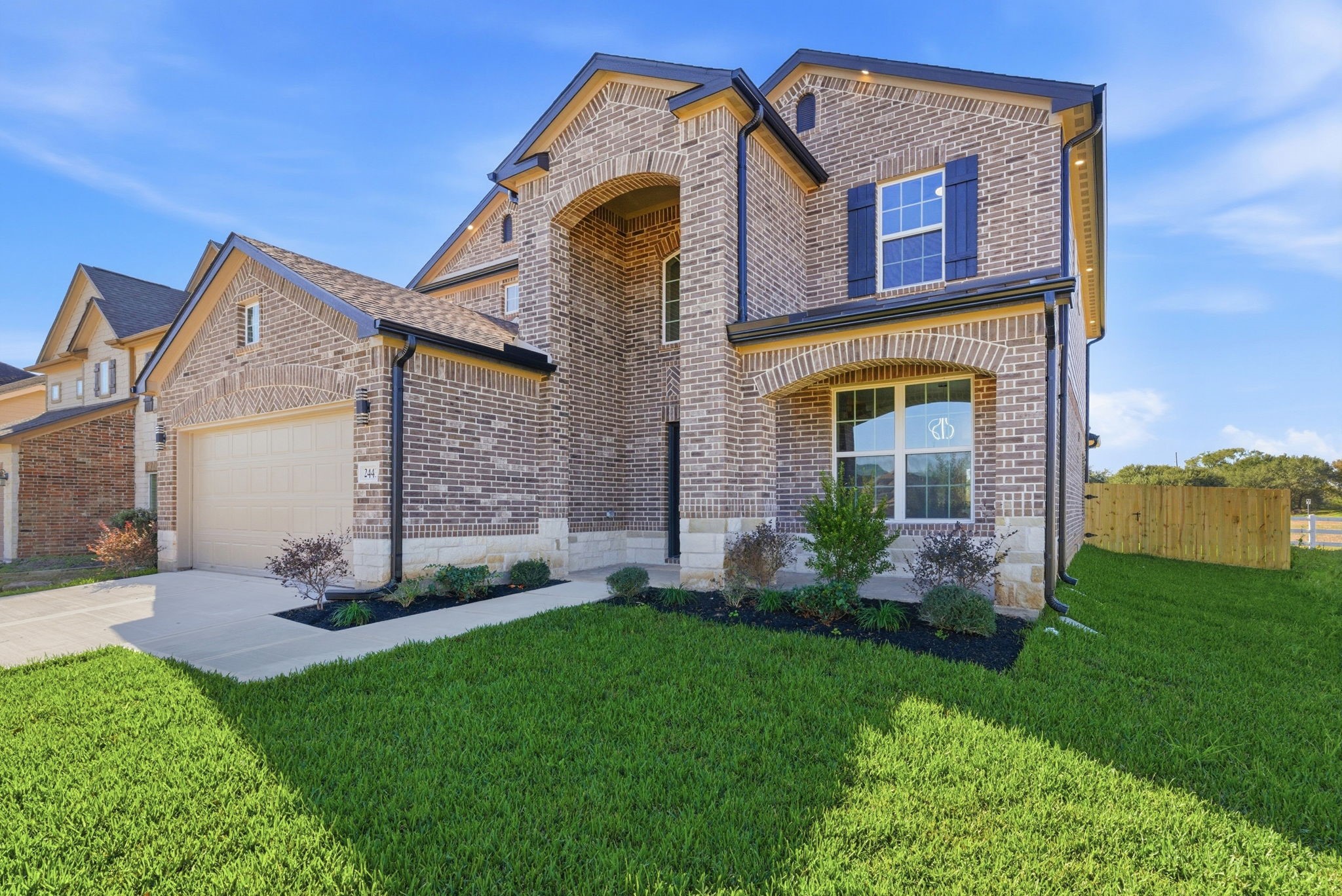 2443 Inlet Court Fresno, TX 77545 - Photo 3 of 50 a view of a house with brick walls and a yard with plants