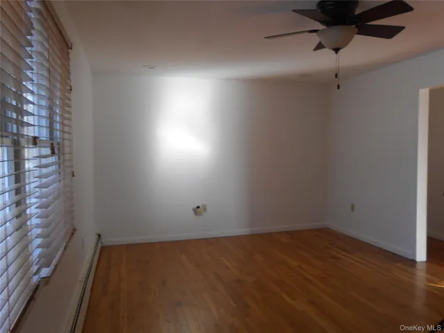 a view of room with window and hardwood floor