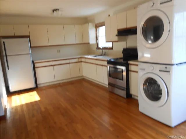 a kitchen with a stove top oven sink and cabinets