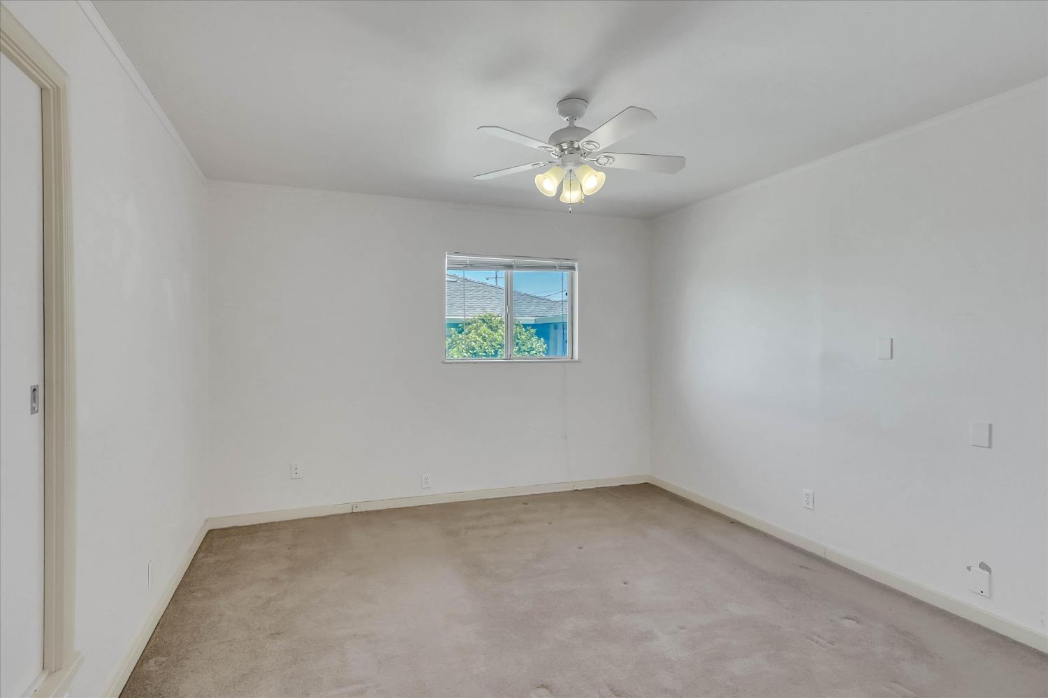 39640 South River Road Clarksburg, CA 95612 - Photo 20 of 25 an empty room with a window and ceiling fan