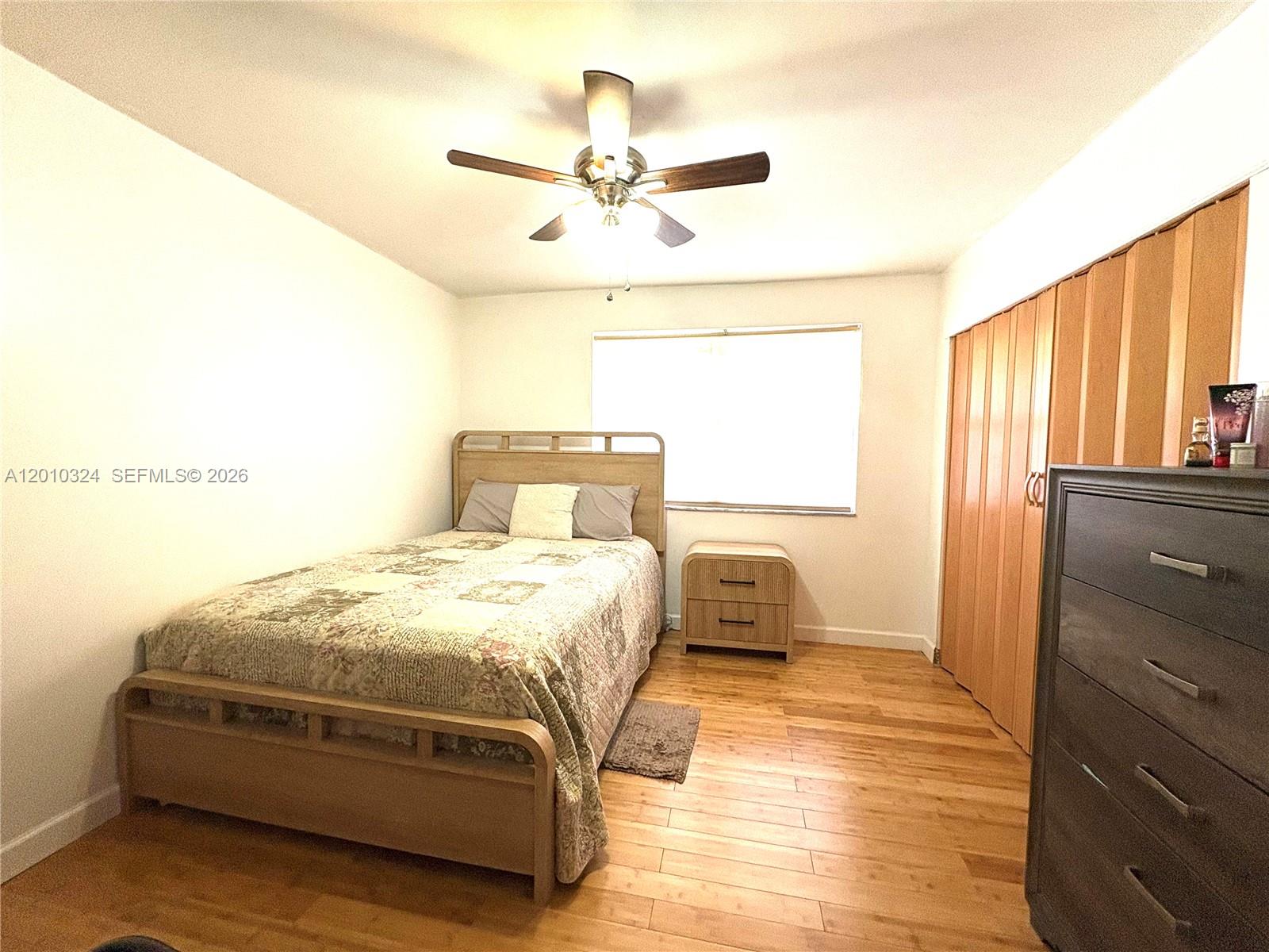 a bedroom with a bed and window