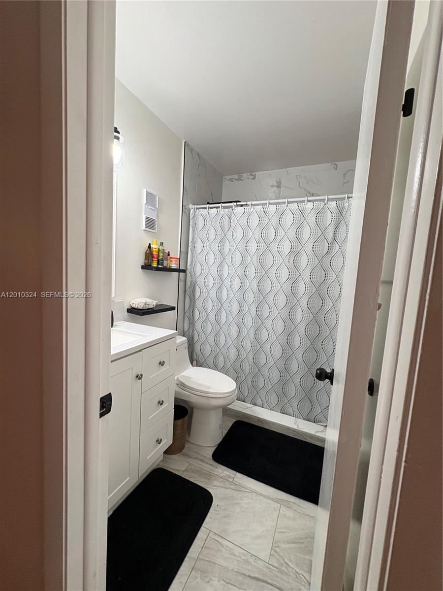 5424 Gate Lake Road, Unit 5424 Tamarac, FL 33319 - Photo 4 of 10 a bathroom with a sink and a shower